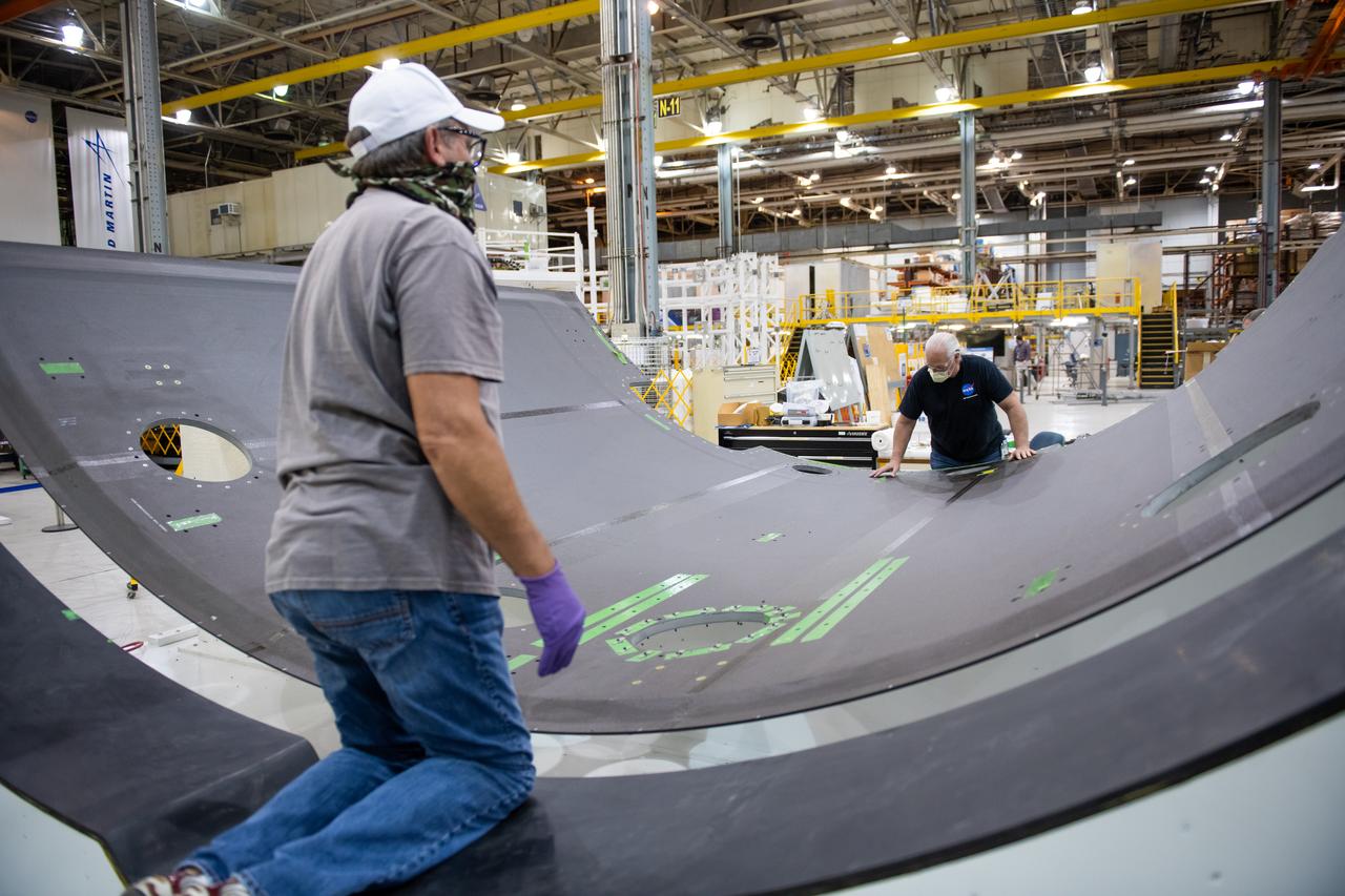 Employees wear personal protective gear at Michoud Assembly Facility as the facility transitioned to Stage 3 of NASA’s Framework for Return To On-Site Work. Employees wear the appropriate personal protective equipment (PPE) and/or cloth face coverings as required for assigned tasks. Access to the facility is limited to authorized personnel working on mission-critical tasks that must be conducted onsite. Mission-critical tasks include slowly and methodically resuming Space Launch System (SLS) Core Stage and Orion production activities, particularly critical path deliverables to support the Artemis Program, at a pace that limits personnel and follows federal guidelines for social distancing and use of personal protective equipment such as face masks. For more information about SLS, visit nasa.gov/sls.